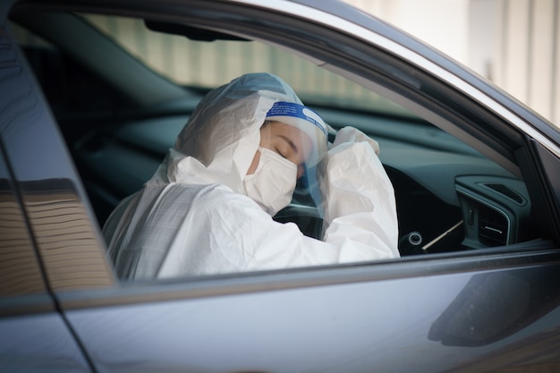 woman-driver-with-gloves-protective-hazmat-suit-face-shield-mask-corona-virus-covid-19-protection_46370-1481.jpg